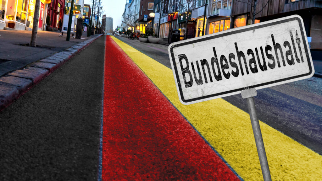 23 January 2024: Street with many houses and light in Germany national colors and a sign with inscription: Bundeshaushal